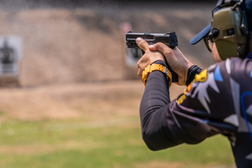 Man shooting a pistol at the shooting range Man shooting a pistol at the shooting range